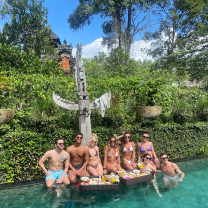 a group of 8 friend enjoting floating breakfast in ubud bali delivered by grazie 