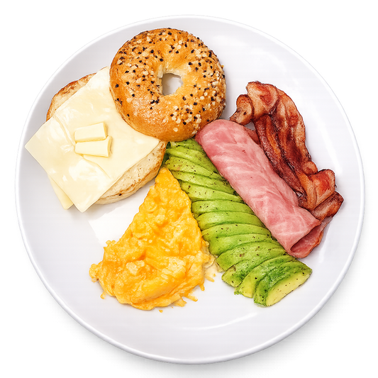 Breakfast plate with bagel, cheese, bacon, avocado, and eggs on a white background