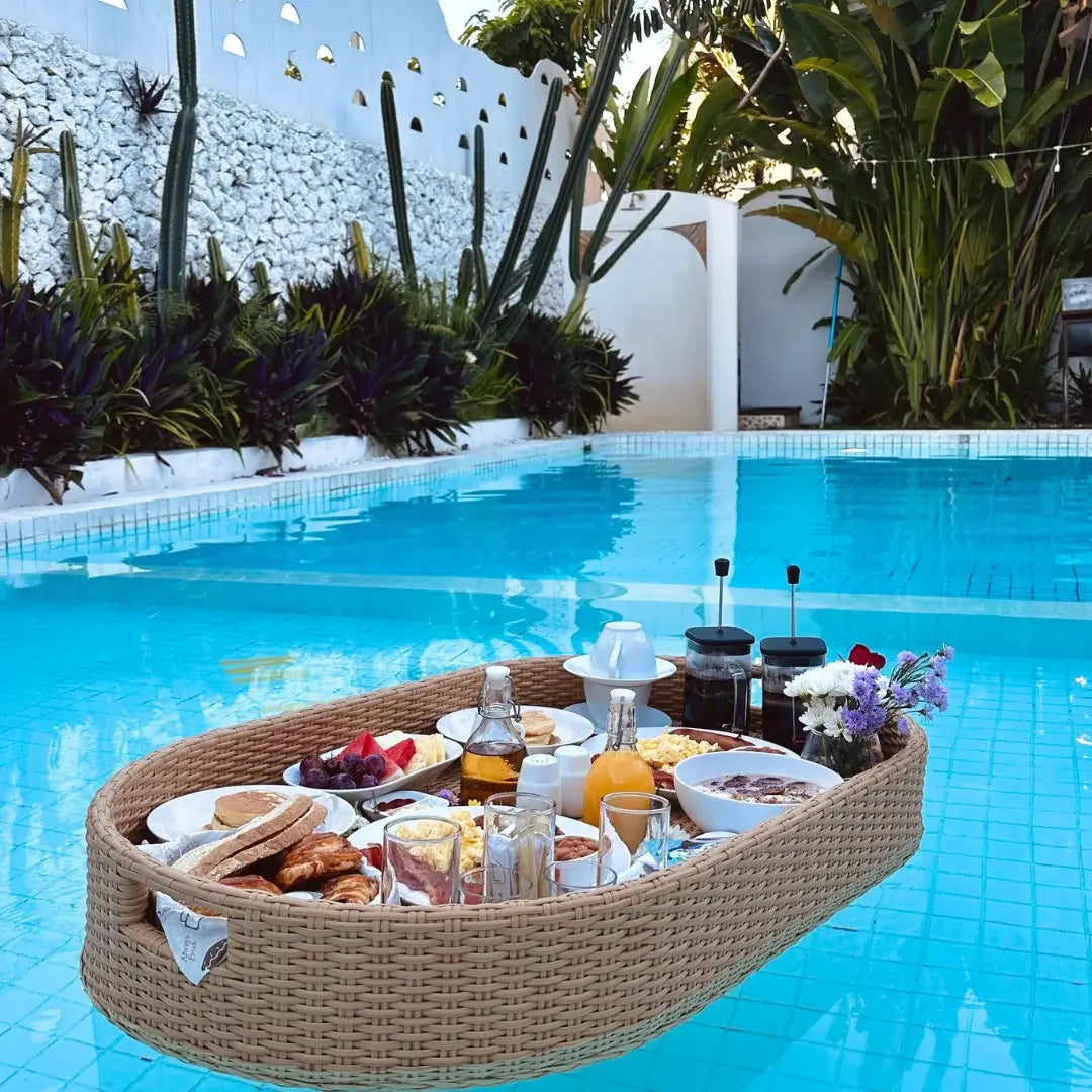 bali floating breakfast tray with pastries, fruits, pancakes, juices, and coffee in a villa pool