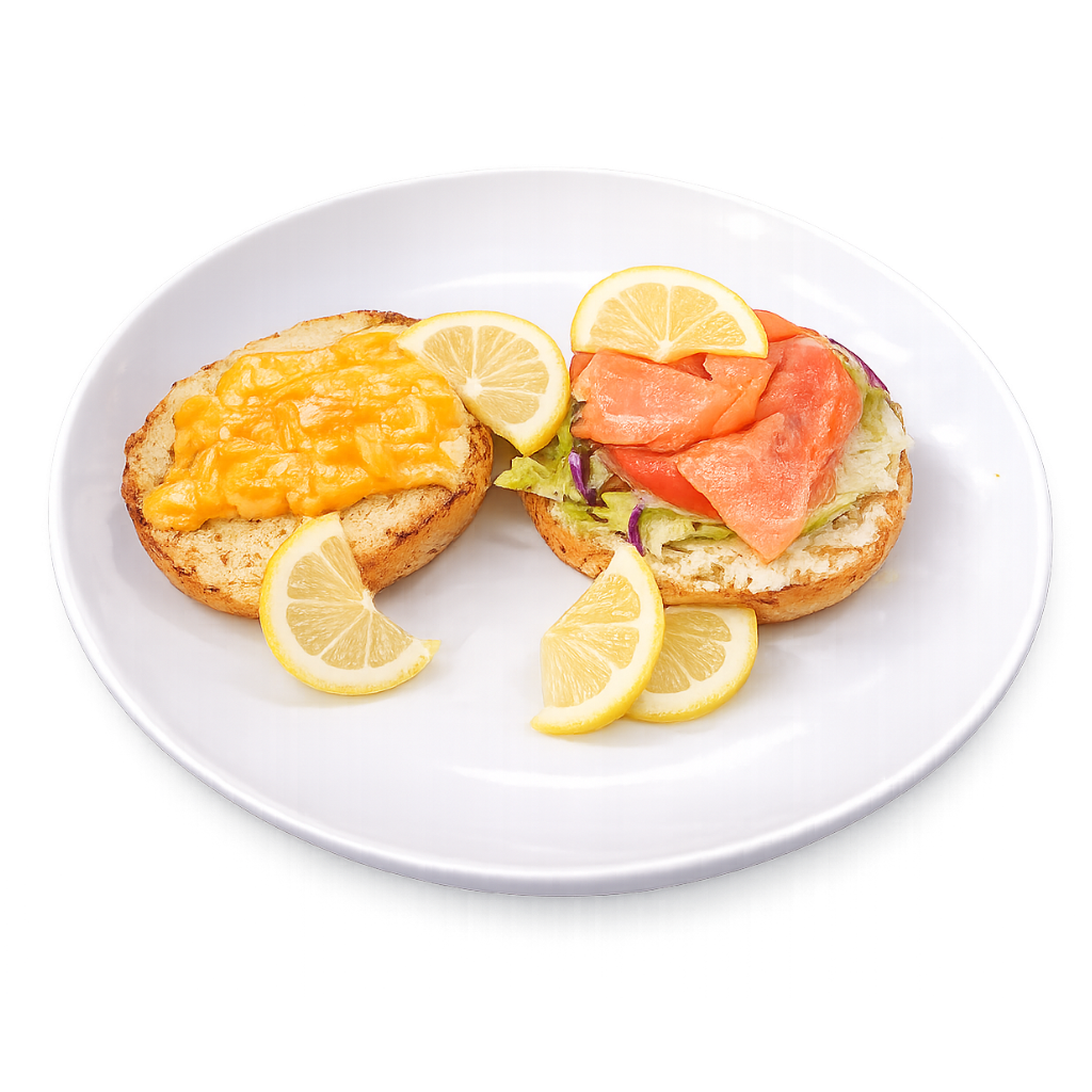 Two bagel sandwiches with different toppings on a white plate with lemon wedges.