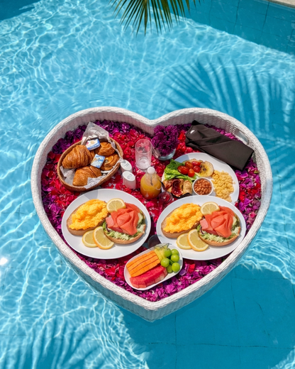 Heart-shaped floating tray with food in a pool